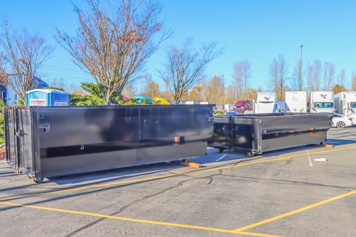 Professional dumpster rental service with roll-off container on residential driveway in Winfield